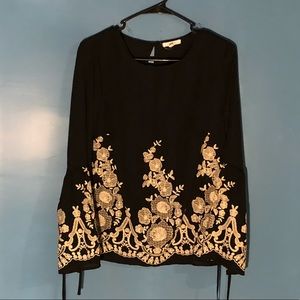 Black top with white/cream floral design